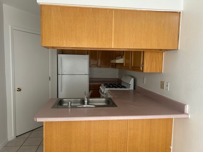 Kitchen with refrigerator, stove and dish washer. Hookups for laundry - 1345 Trudy Elaine Dr