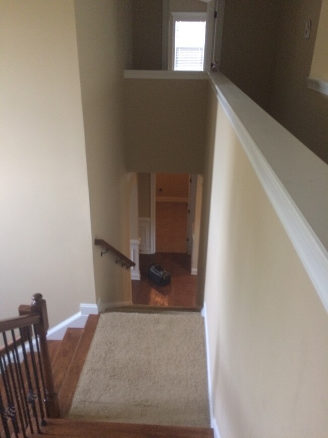 Dual staircase- 1 leads 2 upstairs&other leads 2 kitchen. View of oversized laundry room from stairs - 319 Haywood Dr