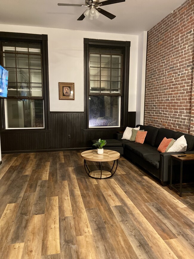 Large living room with large windows facing 4th street - 36 W 4th St