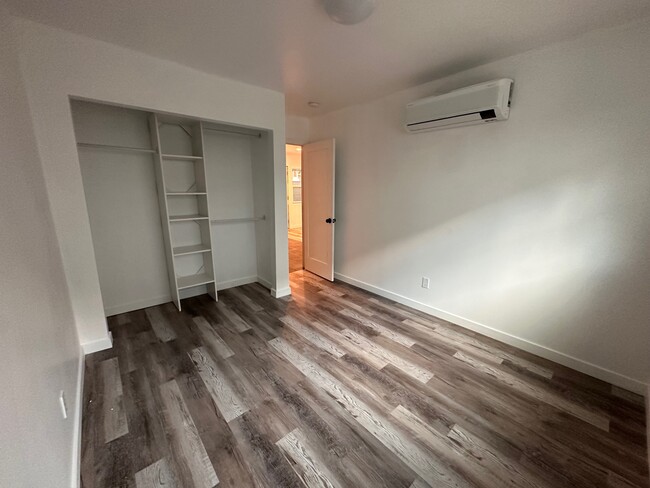 Bedroom with closet organizer and AC/heater unit - 2146 Felspar St