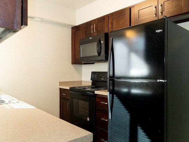 Kitchen with Black Appliances - Crossroads Apartments