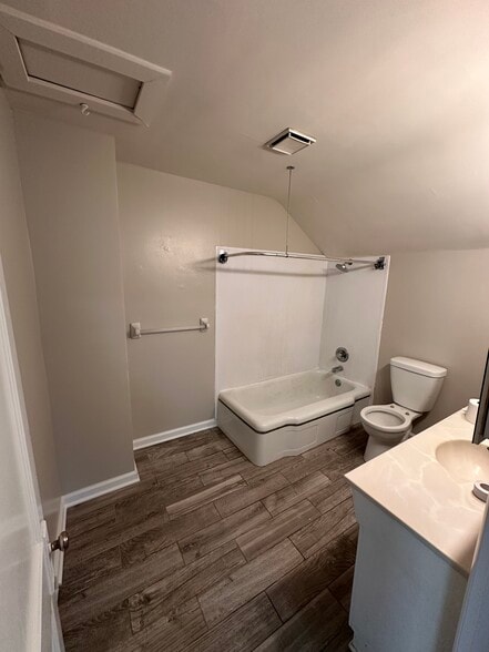 bathroom with tub and shower and newer flooring - 4308 Francis St