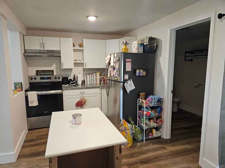 New kitchen with stainless steel appliances. Half bath and laundry here. - 149 W Sheridan Ave