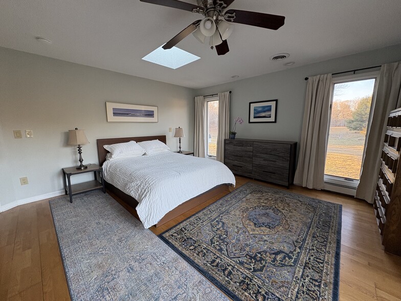 3 floor-to-ceiling windows in the bedroom look out to peaceful, wide open spaces. - 683 Richies Way