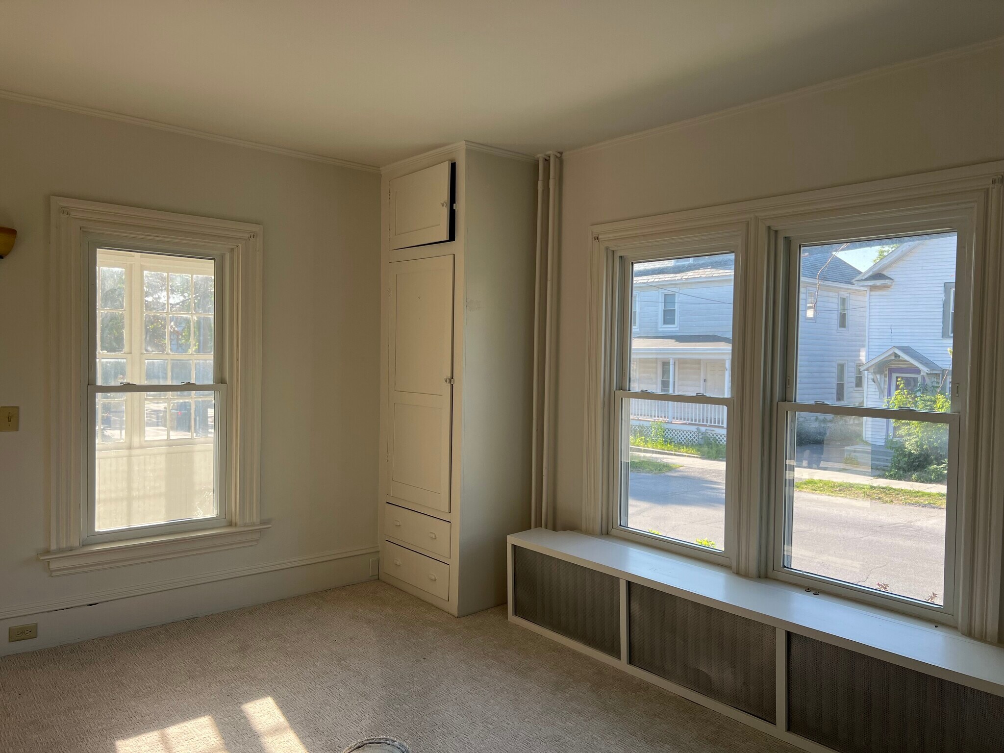 Large bedroom with windows to porch, front of house and side yard. - 401 North St