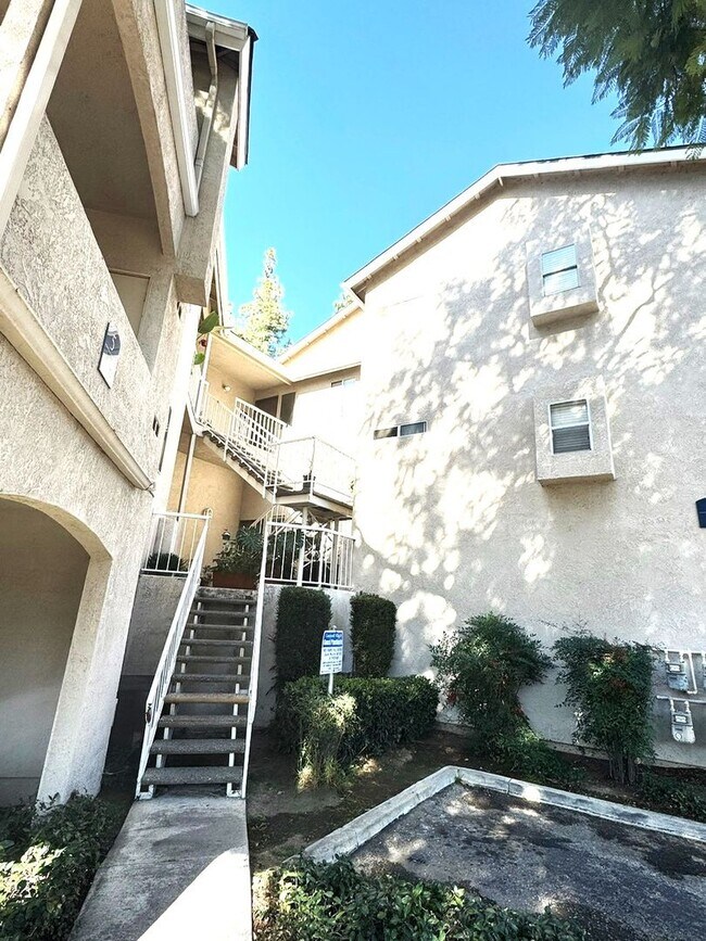 Building Photo - 2 Bedroom, 2 Bath Upstairs Condo with Private Balcony & 2-Car Garage, Gated Community, Water/Tras...