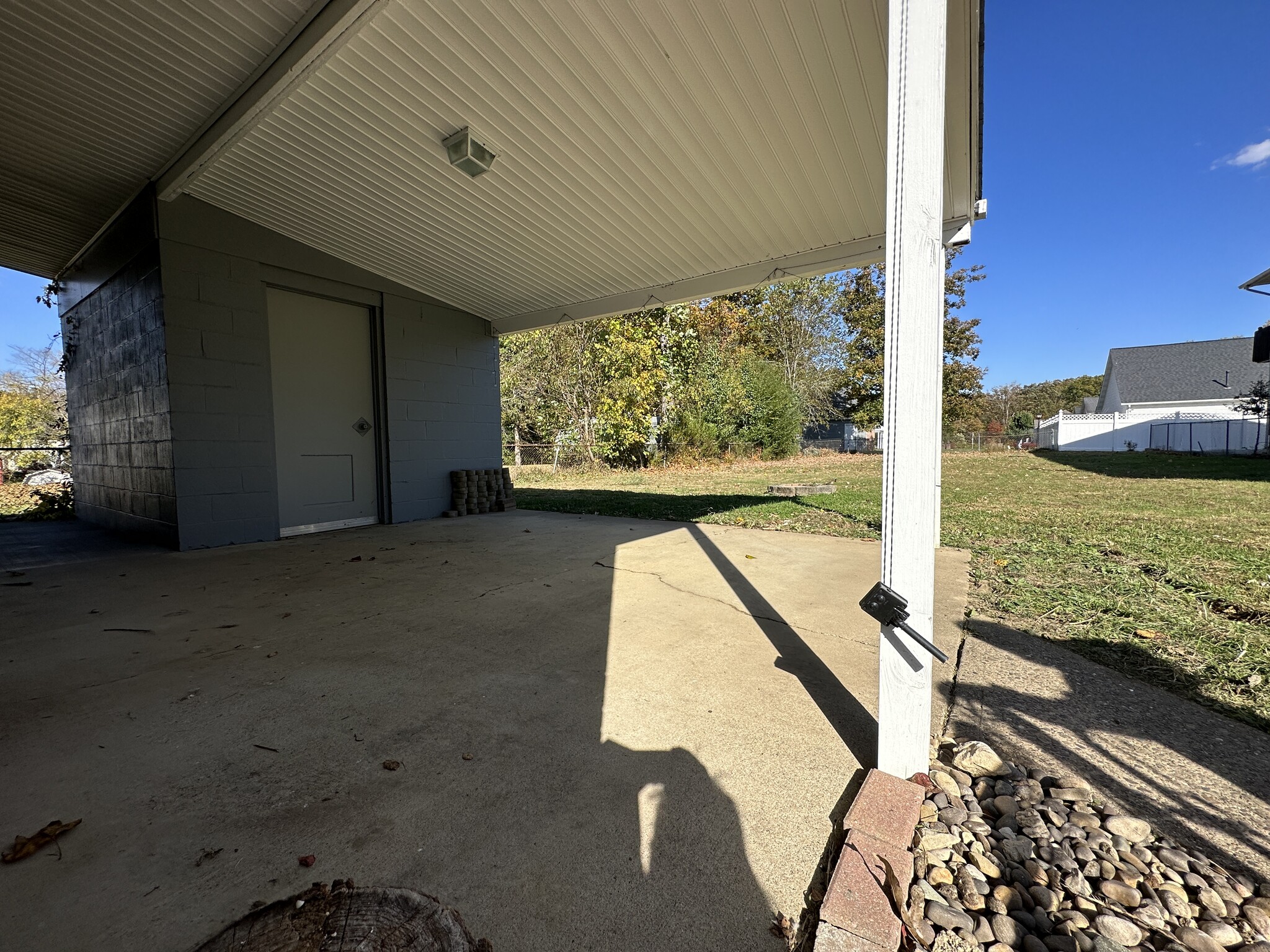 Additional view of porch, storage building and fenced yard. - 6120 Pinedale Dr