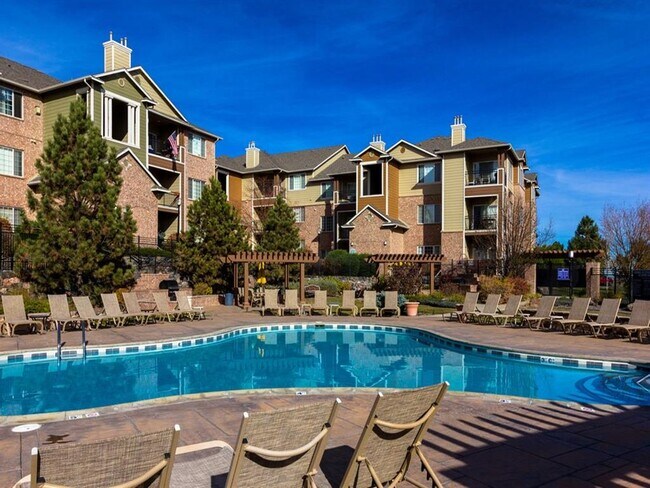Pool with Sun Deck and Lounge Chairs - Indigo Creek Apartments