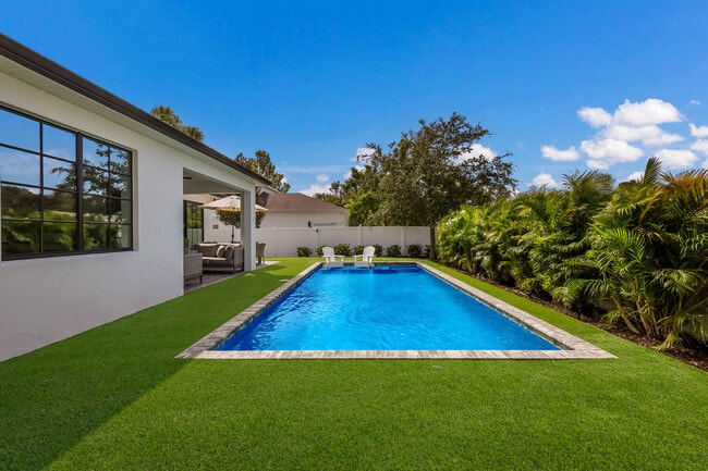 Pool area surrounded by field turf - 3224 S East Ave
