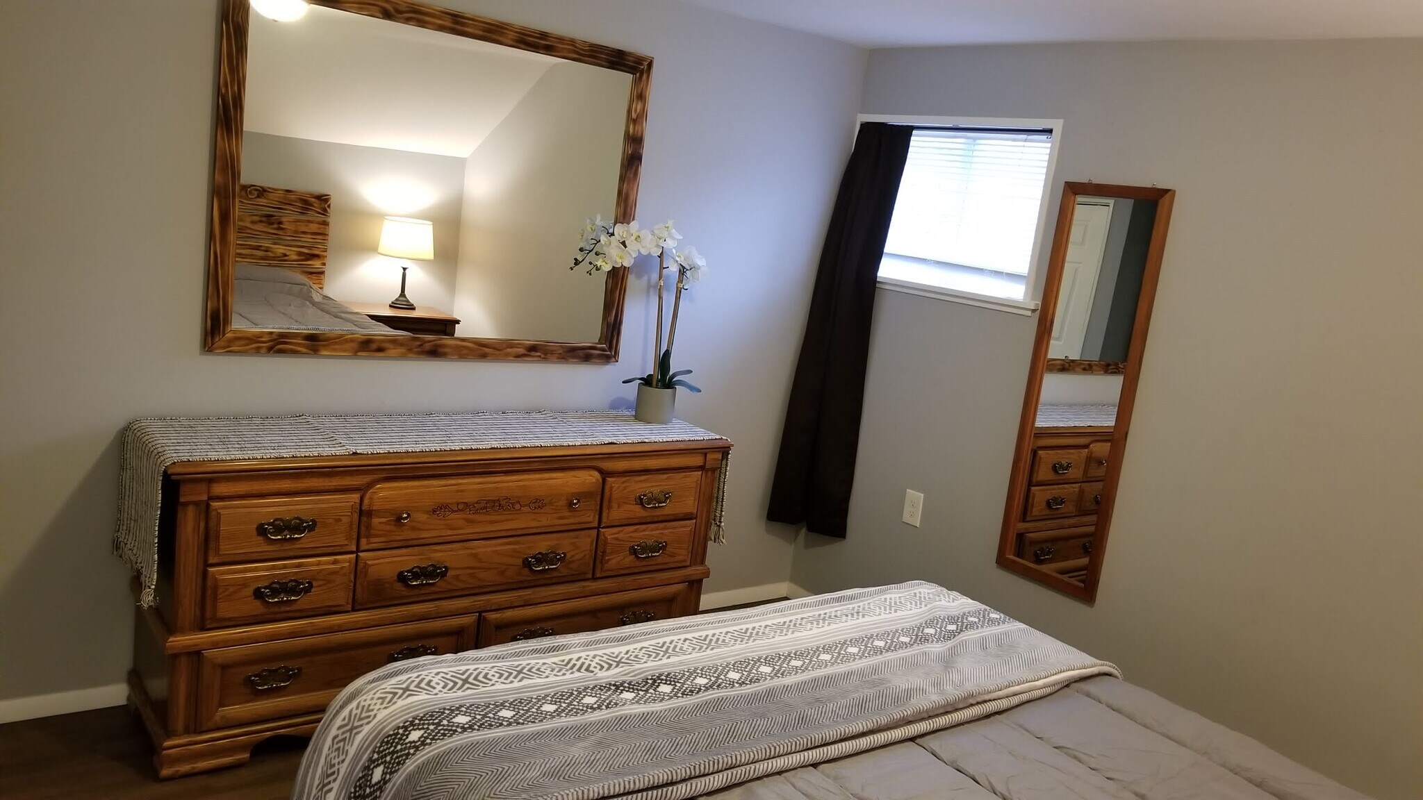 Bedroom with blackout curtain and full length mirror - 715 Main Street