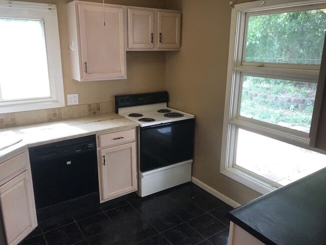 Building Photo - Nice, 4BR rancher with appliances, attached garage and fenced back yard.