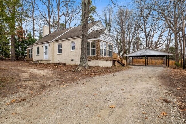 Building Photo - Brick home, Two Story, Hardwoods, DR, 2 Sun Rooms, FP, Carport!.