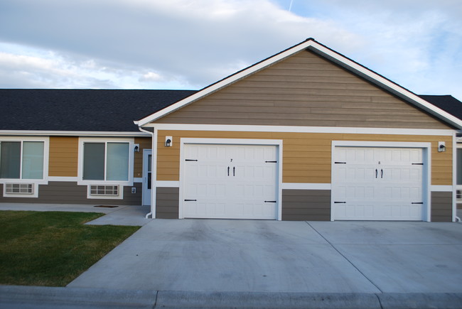 Exterior with attached garage included in rent - Wheatbaker Patio Home Apartments