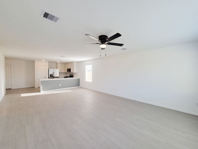 Building Photo - This single-level home showcases a spacious open floorplan shared between the kitchen, dining are...