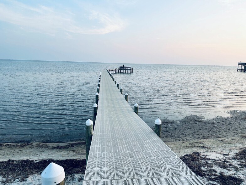 It comes with a fishing pier with bench, picnic tables, fire pit, grill. - 6464 Starfish Cv