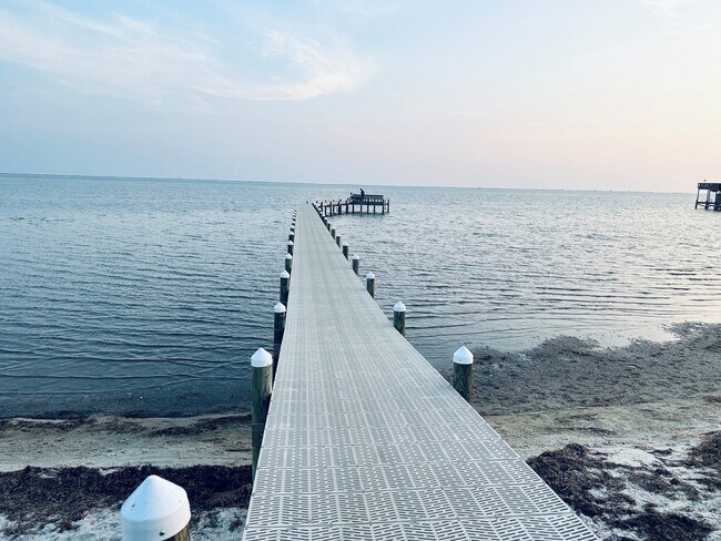 It comes with a fishing pier with bench, picnic tables, fire pit, grill. - 6464 Starfish Cv