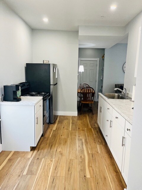 Galley kitchen with full-sized fridge, oven/stove - 188 S Champlain St