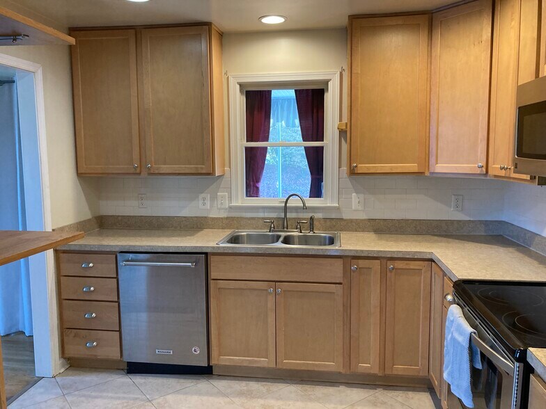 View of kitchen to screened sunroom - 7288 Beechtree Ln