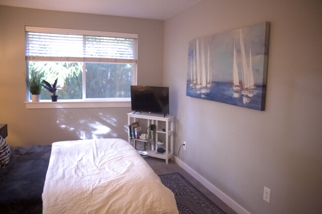 Bedroom 2 with smart TV, workspace, and closet. - 1045 NE 115th St