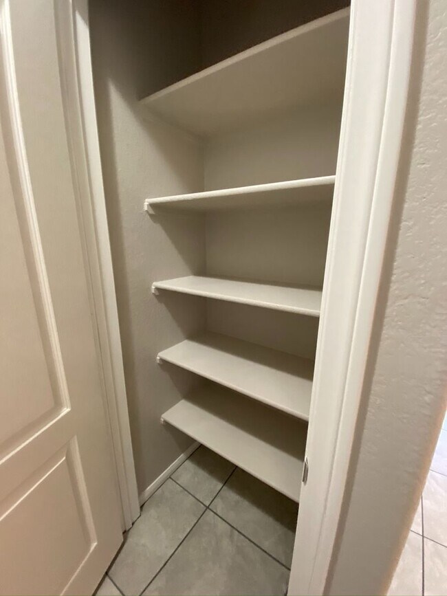 Building Photo - BEAUTIFUL CONDO IN A GATED COMMUNITY FEATURING PLANTATION SHUTTERS, TILE FLOORING AND NEW PAINT T...