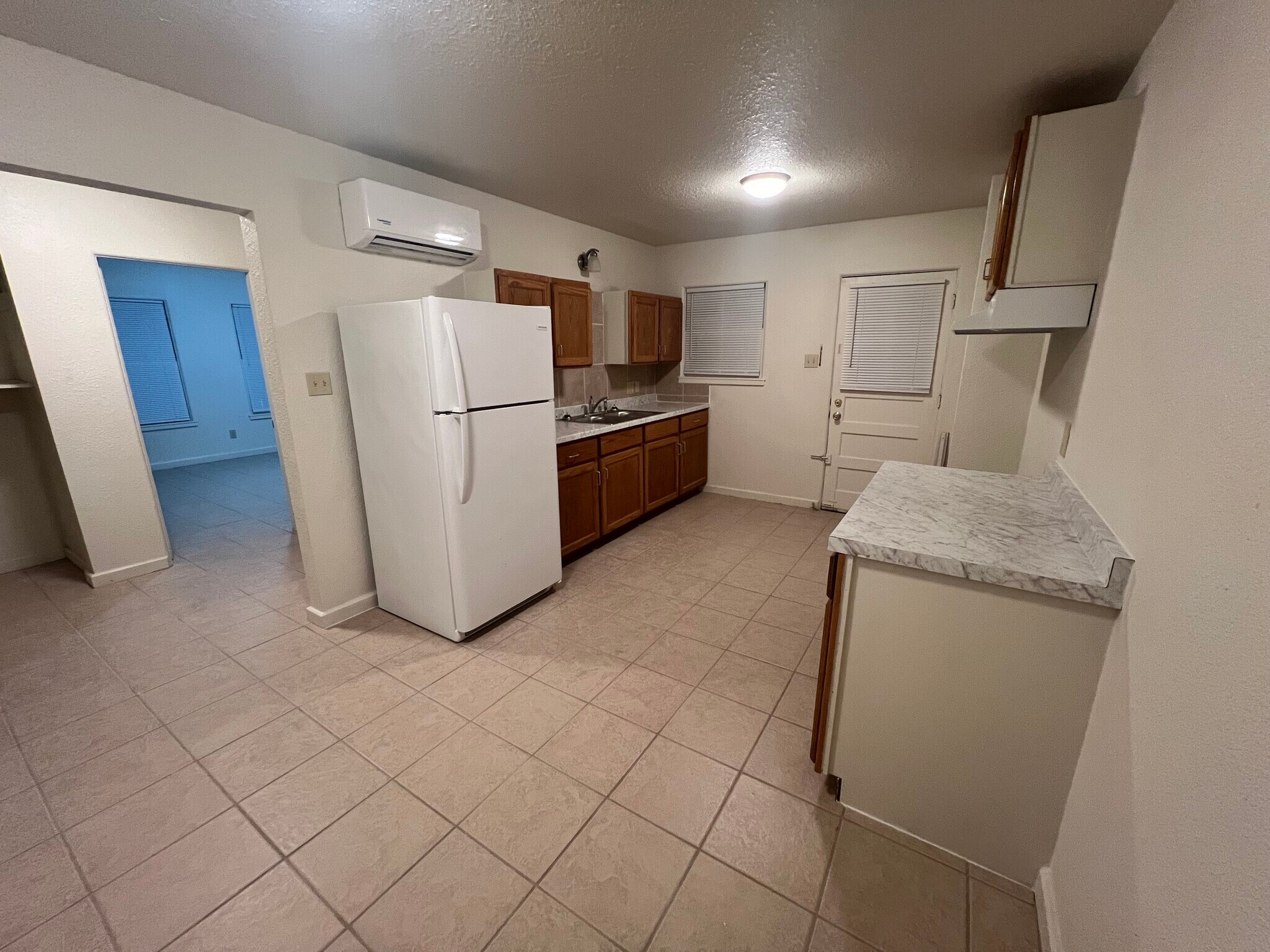 Kitchen with refrigerator & stove (to come). 14’x10’ Mini-split. - 217 N 1st St