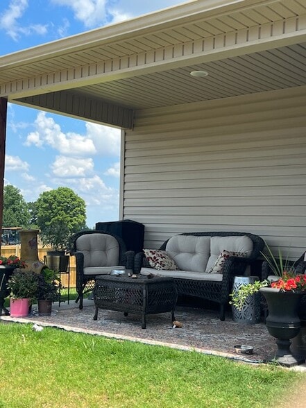 Covered bank porch overlooks fenced backyard - 2904 Emil Dr