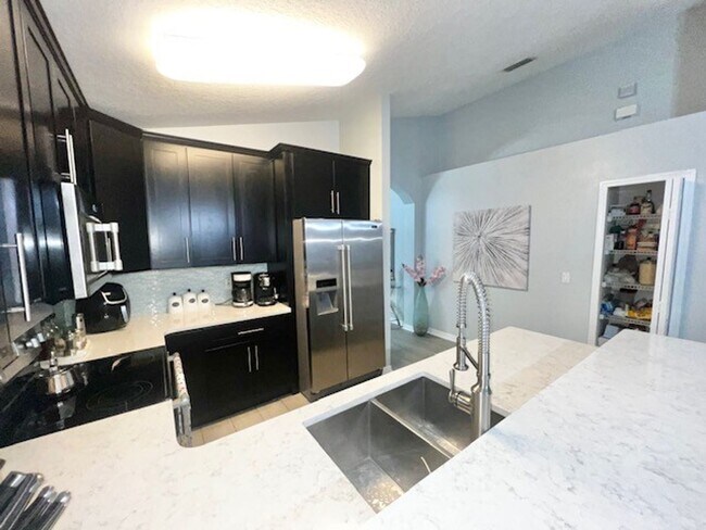 Building Photo - Lake Nona!! Spectacular 4X2 in Gated Nona Crest! All tile flooring!! 2 car garage! Move in April ...