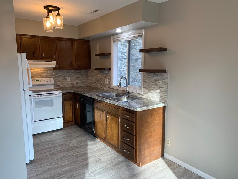 Kitchen with stacked stone backsplash and open shelving - 4832 Ginny ave