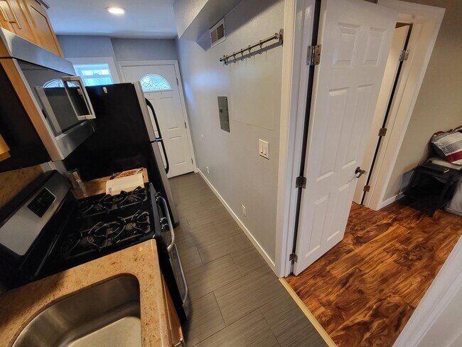 Kitchen with view into studio room and door to private entrance. - 2206 Lincoln Ave