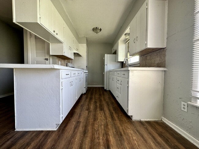 Building Photo - Updated Home with Gorgeous Floors & Large Backyard