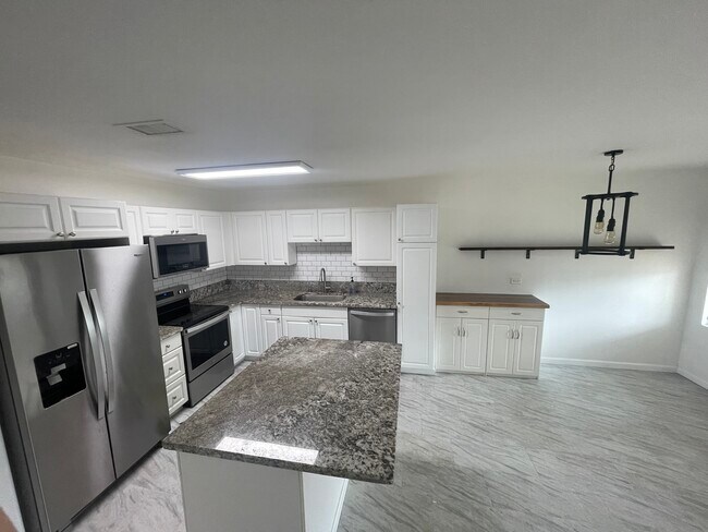 View of kitchen and dining area from stairs - 91-1031 Kaipalaoa St
