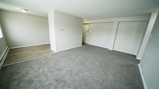 Living room with a view into the kitchen - Brynfield Court Apartments