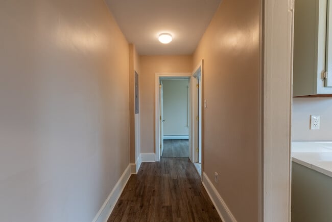Hallway connecting outside of kitchen to bathroom and office/extra bedroom. - 506 Washington St