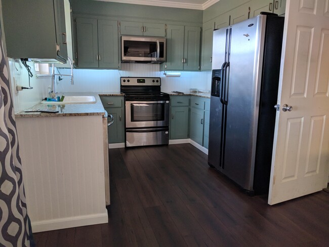 Kitchen with granite countertops and stainless steel appliances - 8716 E 47th Pl