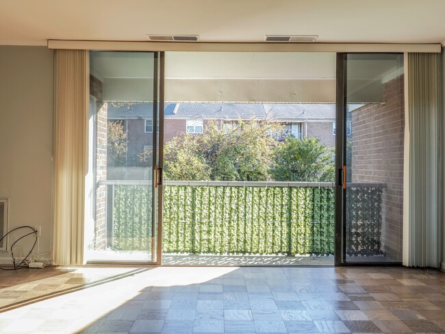 Living room and balcony with privacy screenny - 702 Quince Orchard Blvd