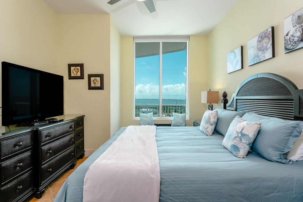 Primary bedroom with view of the bay - 310A Padre Blvd