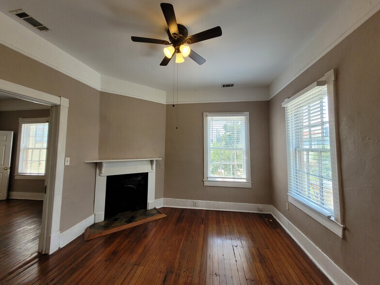 Back Bedroom - Original hardwood floors, Levolor blinds, decorative fireplace, & ceiling fan with li - 1217 Java Pl