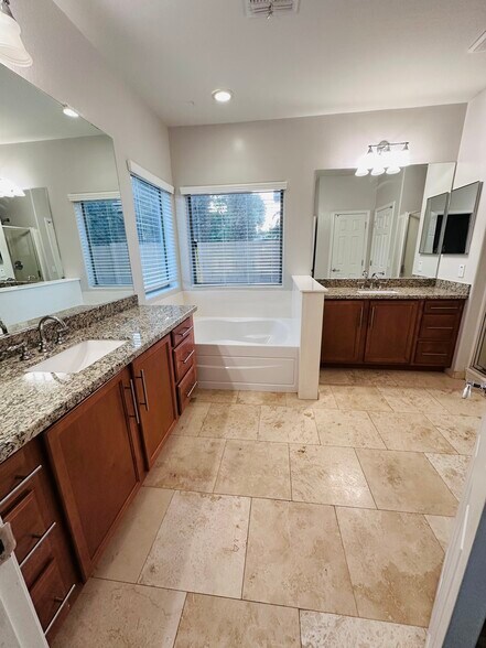 Master bathroom with dual granite sinks. Separate shower and tub - 18215 W Townley Ave