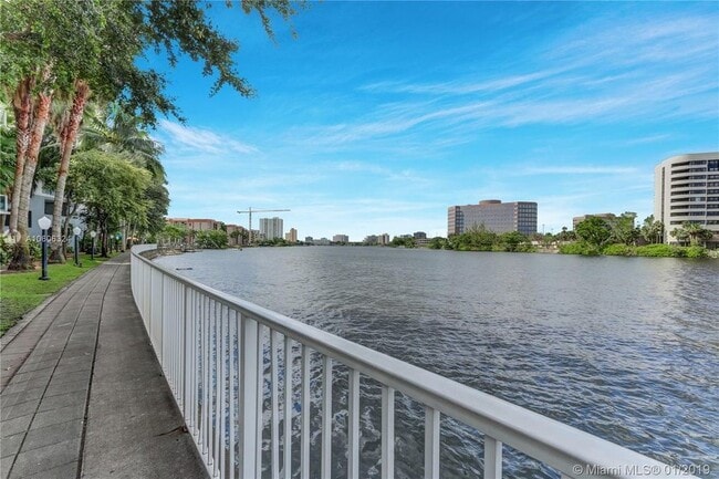 Building Photo - Rare 2/2 Corner Penthouse with Panoramic Lagoon Views from Every Room – Available Now!