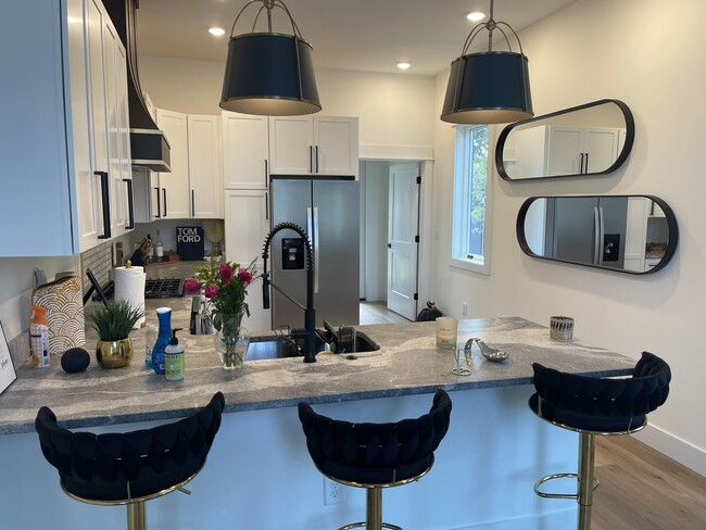 Kitchen with Laundry and back door toward the back. - 2312 Island Home Ave