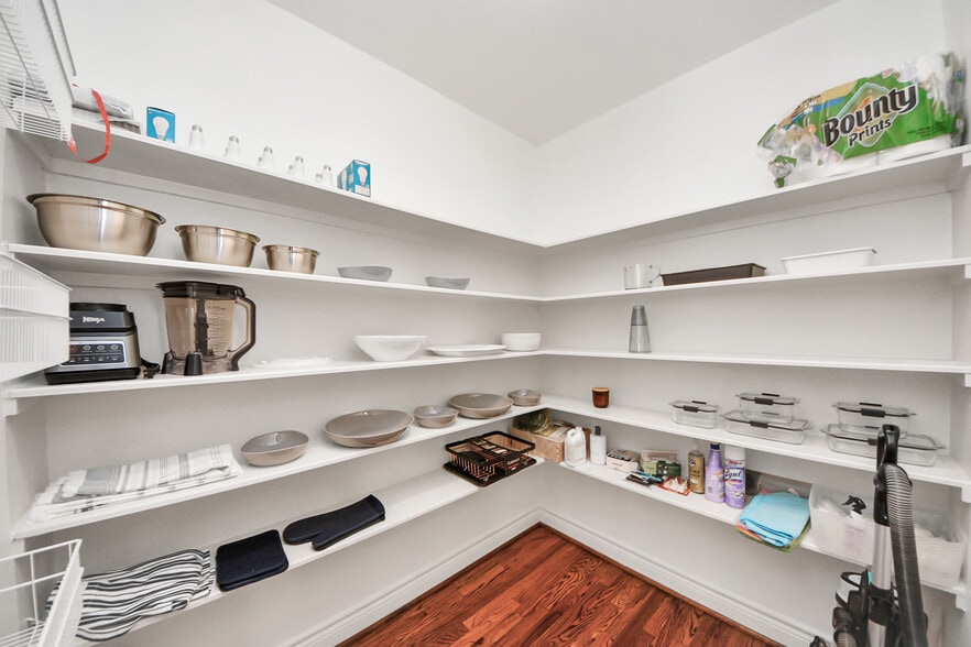 A generous pantry with open shelving and thoughtful order. - 620 Rutland St