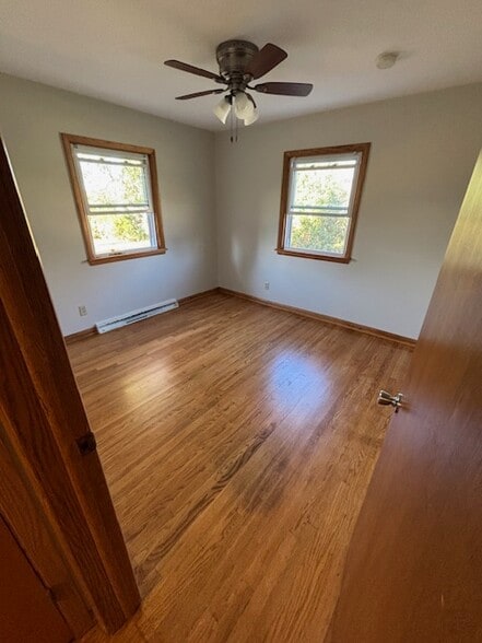 Bedroom 3 with freshly varnished hardwood floors - 409 Hill N Dale Cir