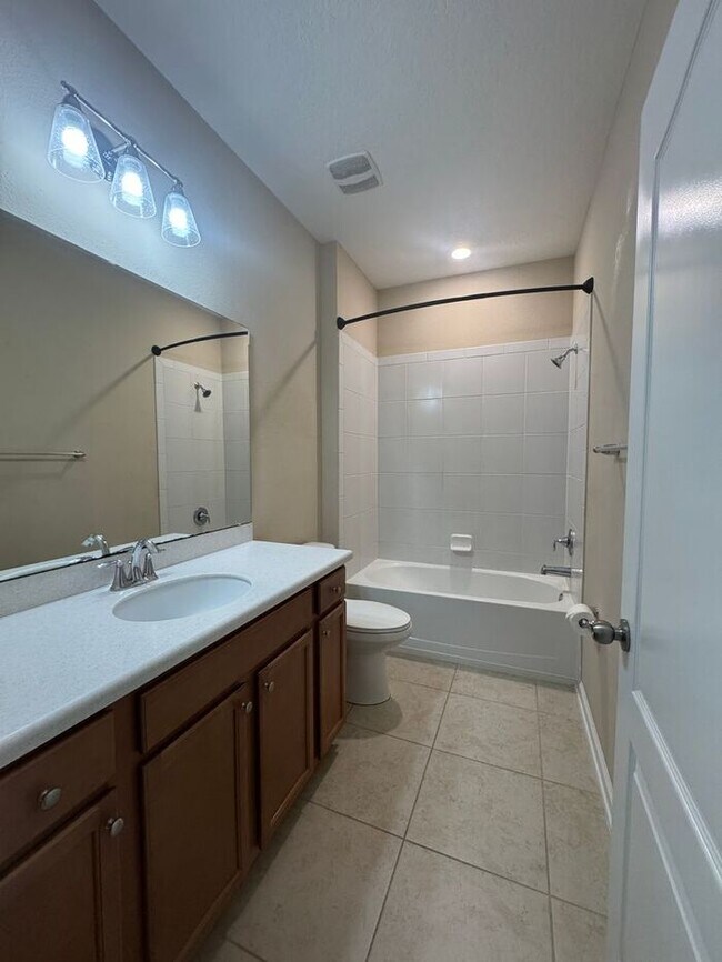 Building Photo - COMING SOON! Beautiful 4BR 3BA Home w/ Screened Lanai & Pond View • Garage Parking • Fenced Yard ...