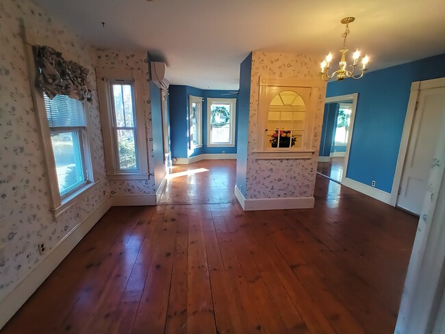 dining room with view of living room bedroom off of the dining room. The front door is to the right - 75 Groton St