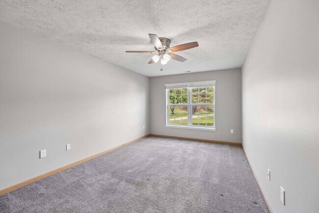 A spacious bedroom with soft natural light and a peaceful atmosphere offers the perfect place to relax and recharge. - Williamsburg Park Apartments