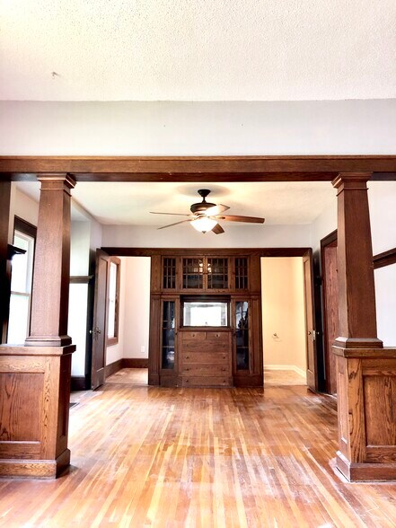 Main floor living/dining room with beautiful wood features and china cabinet. - 816 3rd St SE