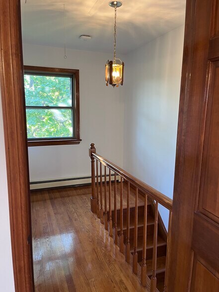 2nd level hallway with wood floor and rail - 239 Kingston Ave