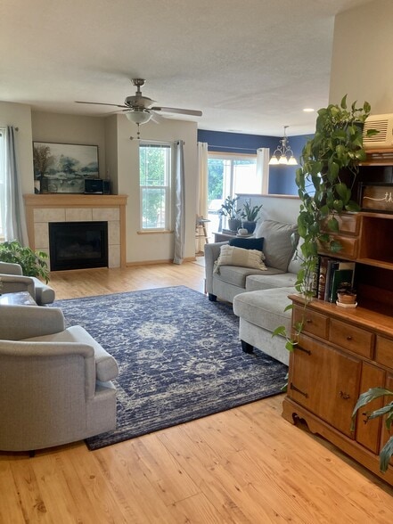 living room with fireplace - 906 SE Crossings Ln