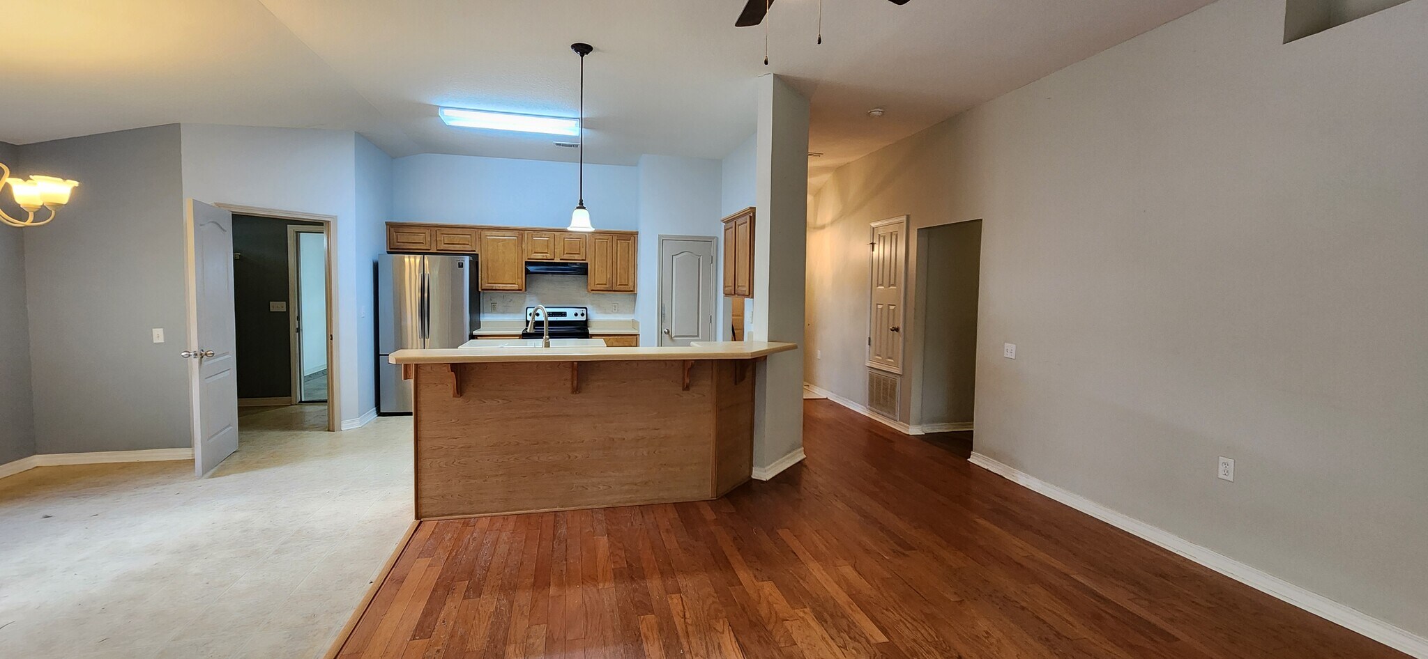 Open concept kitchen and living room with bar - 2318 Tall Oak Dr