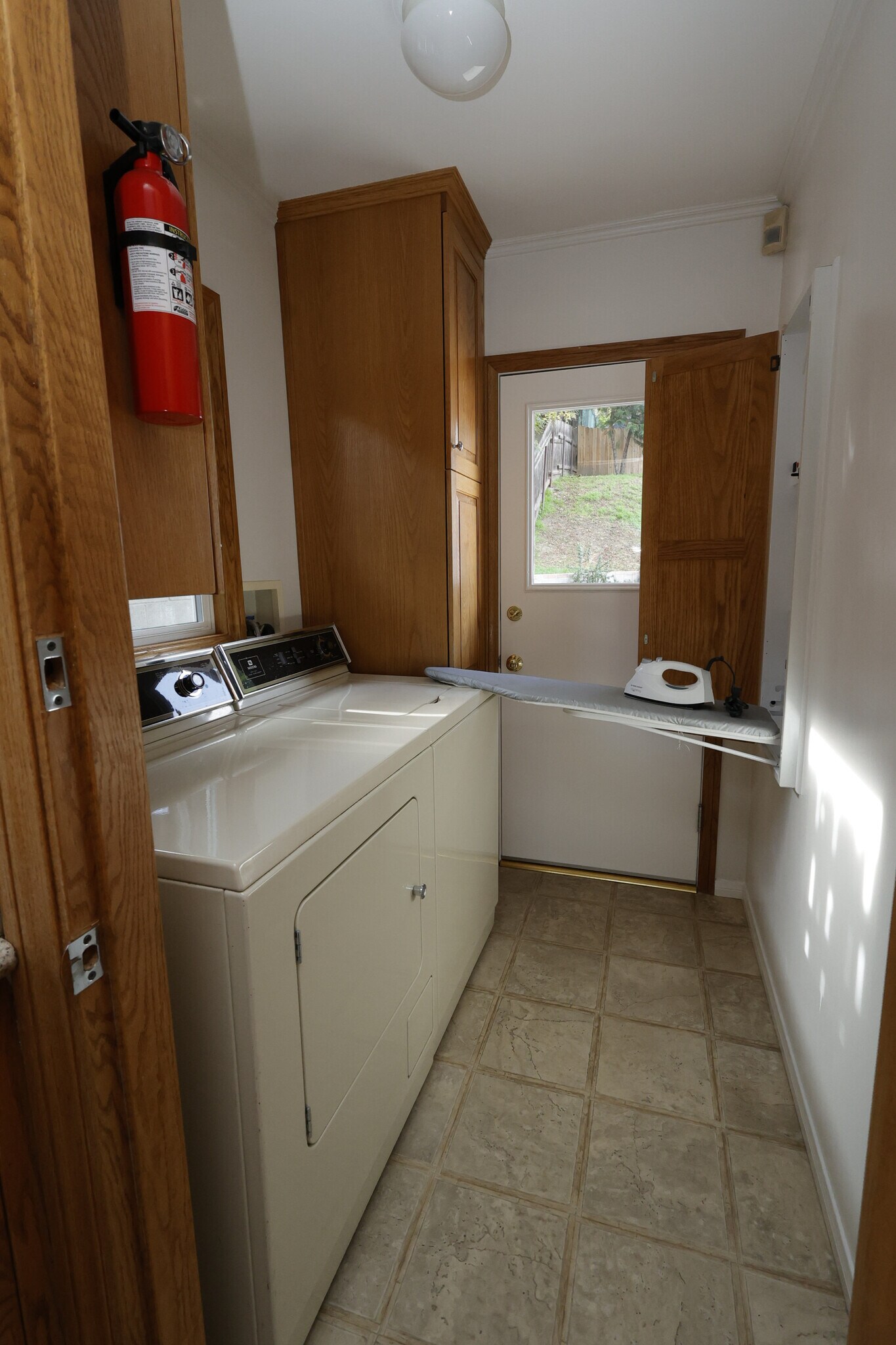 a custom retractable wall-mounted ironing board and iron that you can pull out and easily fold away - 4831 Canoga Ave